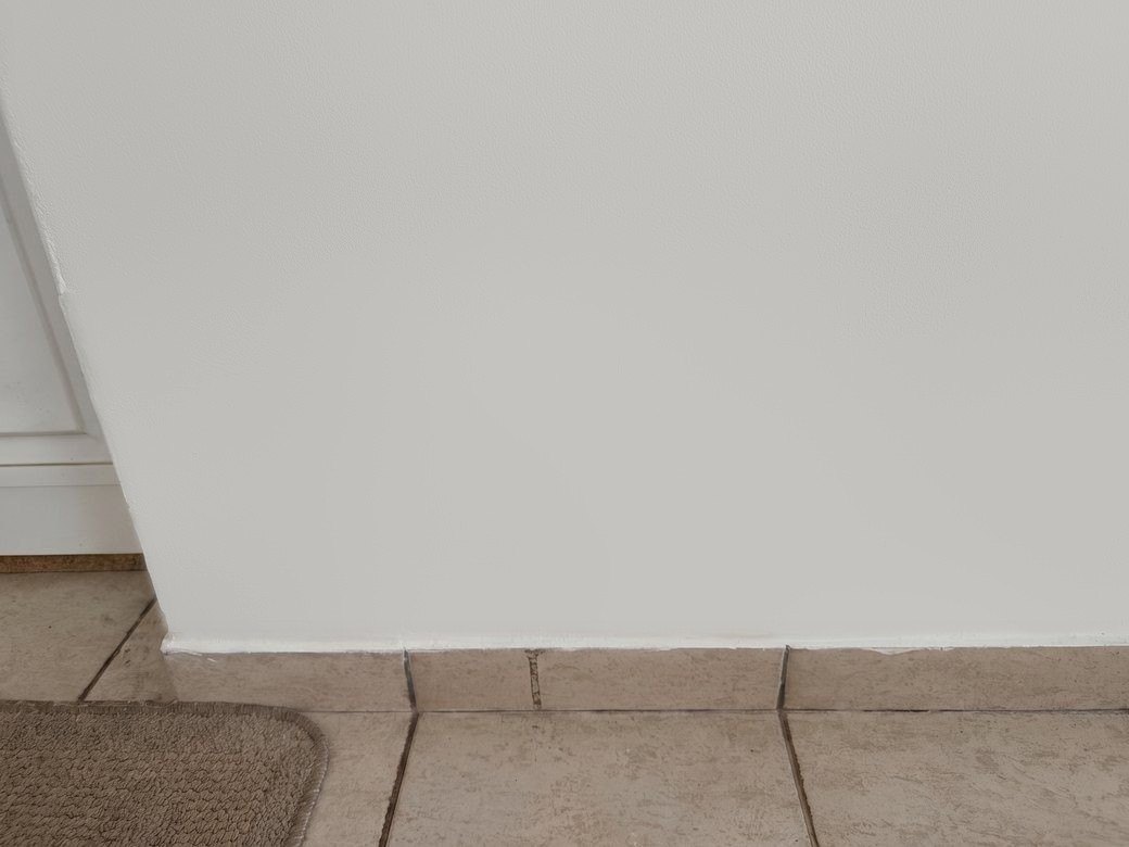 The same wall after replastering and redecoration, clean and dry